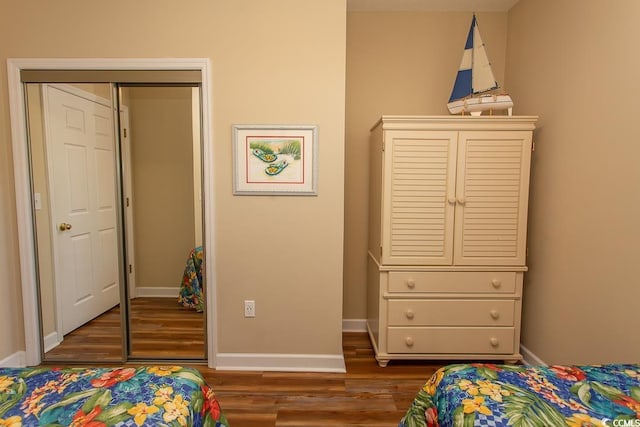 bedroom featuring dark hardwood / wood-style flooring and a closet