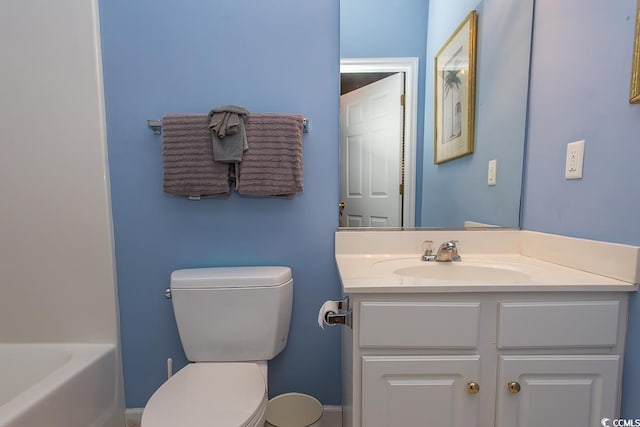 bathroom with a bathing tub, vanity, and toilet