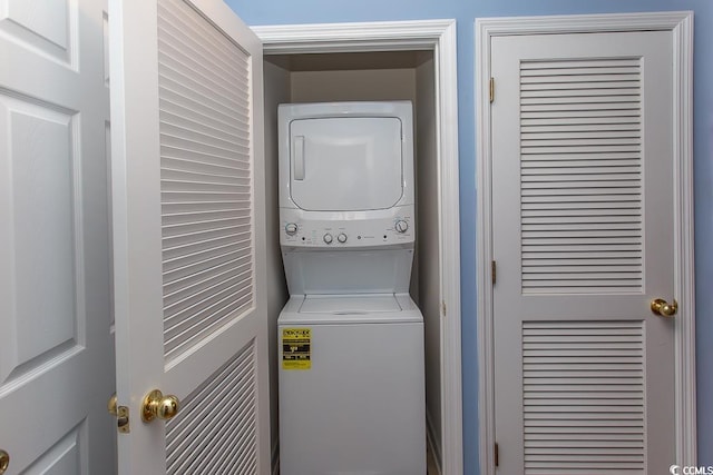 washroom featuring stacked washer and dryer