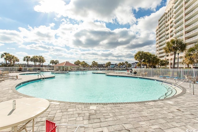 view of swimming pool featuring a patio area