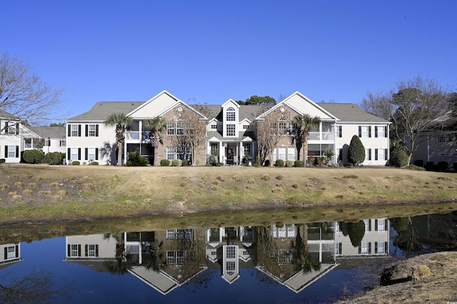 rear view of property with a water view