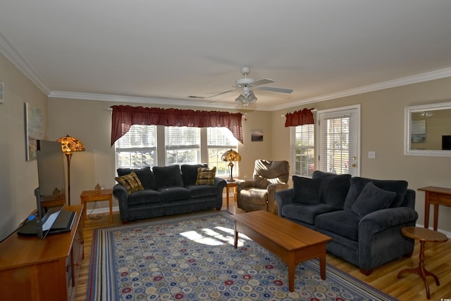 living room featuring wood-type flooring, ceiling fan, and crown molding