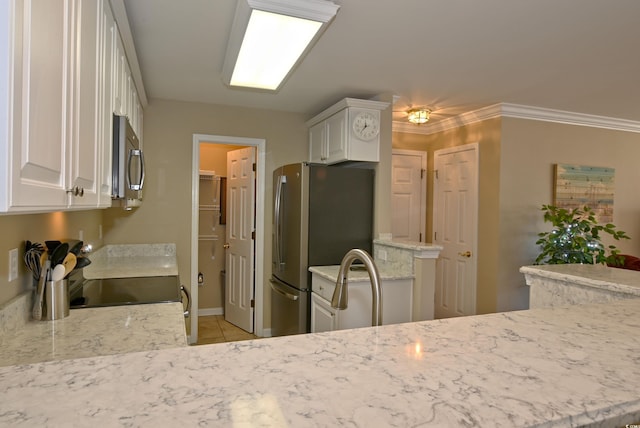 kitchen with white cabinets, sink, light stone countertops, and stainless steel appliances