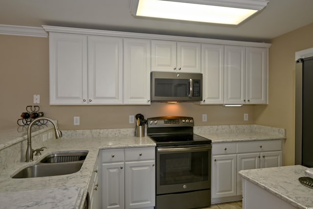 kitchen featuring white cabinetry, sink, and stainless steel appliances