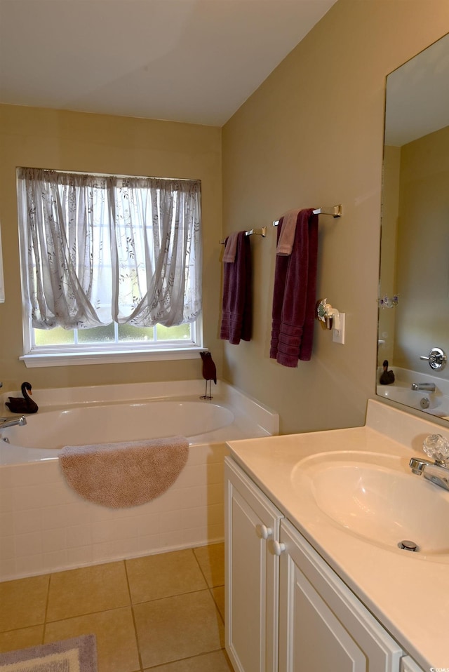 bathroom with a bathing tub, tile patterned flooring, and vanity