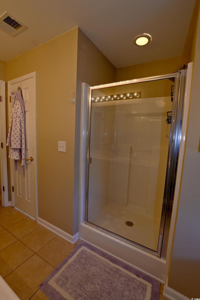 bathroom featuring tile patterned flooring and an enclosed shower