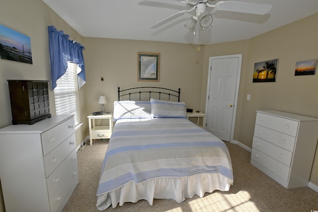 bedroom with ceiling fan and light carpet