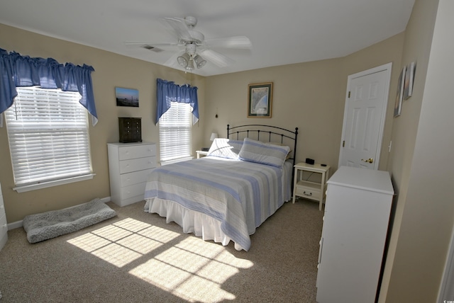 bedroom with ceiling fan and light colored carpet