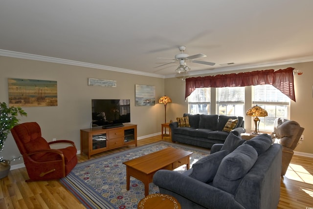 living room featuring ceiling fan, ornamental molding, and light wood-type flooring