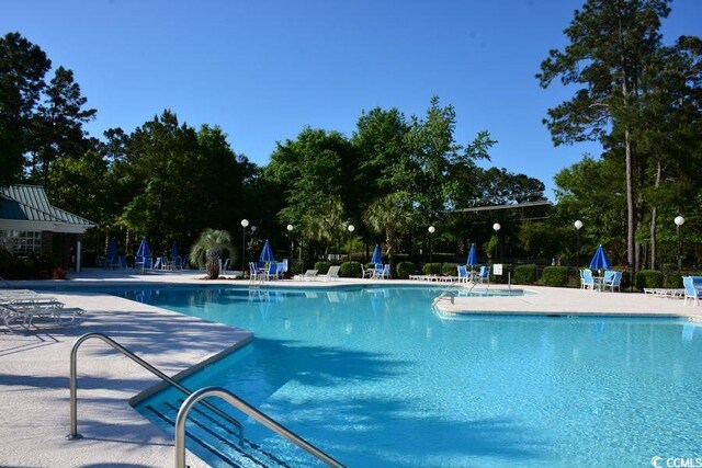 view of swimming pool featuring a patio area