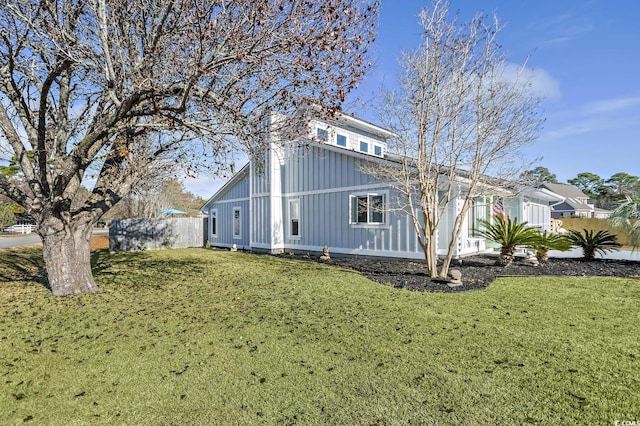 view of side of property featuring a yard