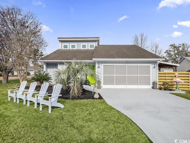 view of front of property with a garage and a front yard