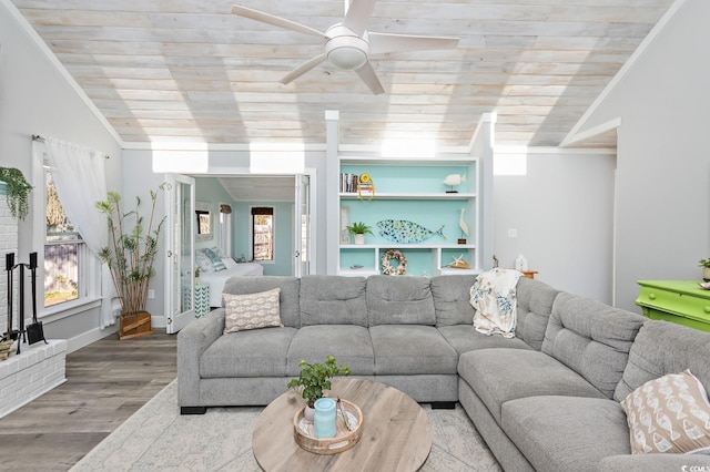 living room featuring a healthy amount of sunlight, hardwood / wood-style floors, wooden ceiling, and vaulted ceiling