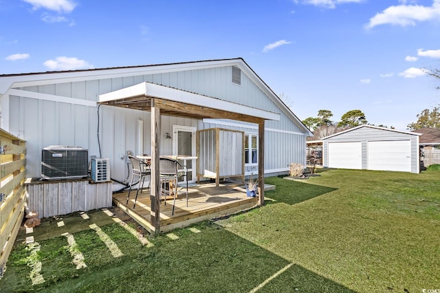 back of property featuring a lawn, cooling unit, an outbuilding, and a wooden deck