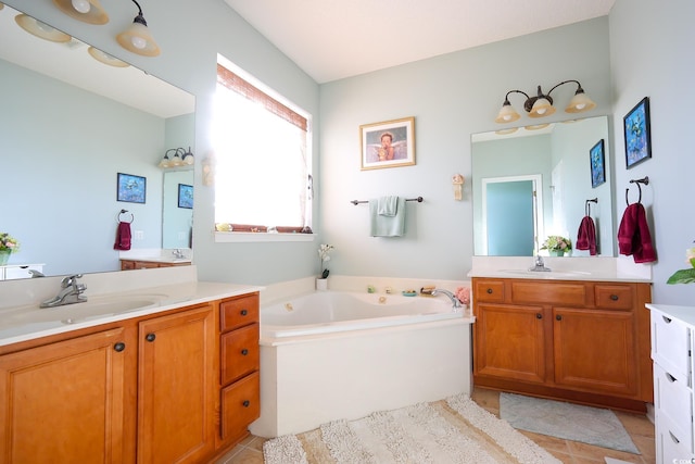 bathroom featuring tile patterned floors, a bathtub, and vanity