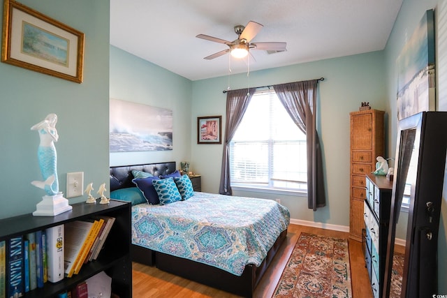 bedroom with ceiling fan and wood-type flooring