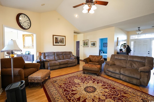 living room with ceiling fan, light hardwood / wood-style flooring, and high vaulted ceiling