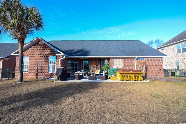 rear view of property featuring outdoor lounge area, exterior bar, a yard, and a patio area