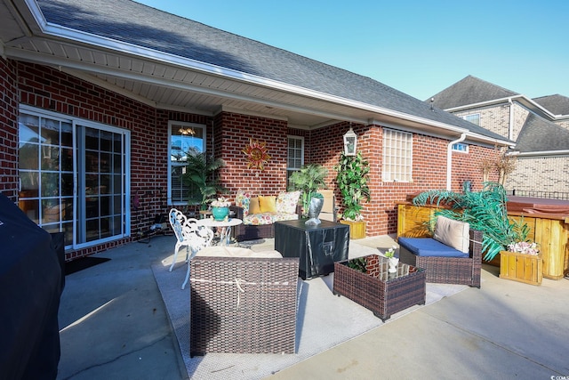 view of patio / terrace with a hot tub, outdoor lounge area, and grilling area