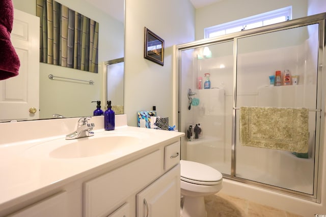 bathroom with toilet, vanity, tile patterned flooring, and an enclosed shower