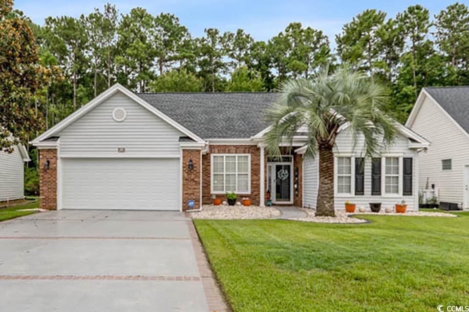 ranch-style home featuring a garage and a front yard