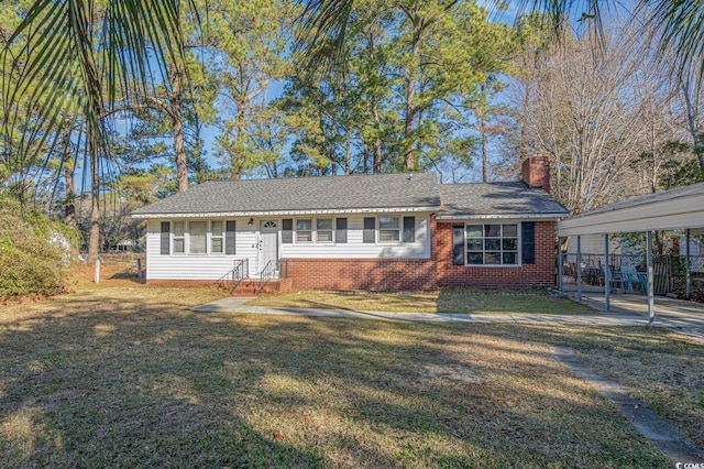 ranch-style home featuring a front lawn and a carport