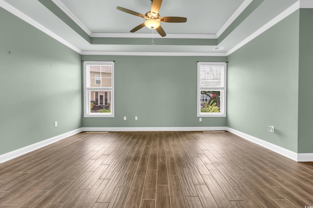 1405 Osprey Pointe Ln, North Myrtle Beach, SC 29582 - unfurnished room with a tray ceiling, healthy amount of natural light, dark wood-type flooring, and ornamental molding