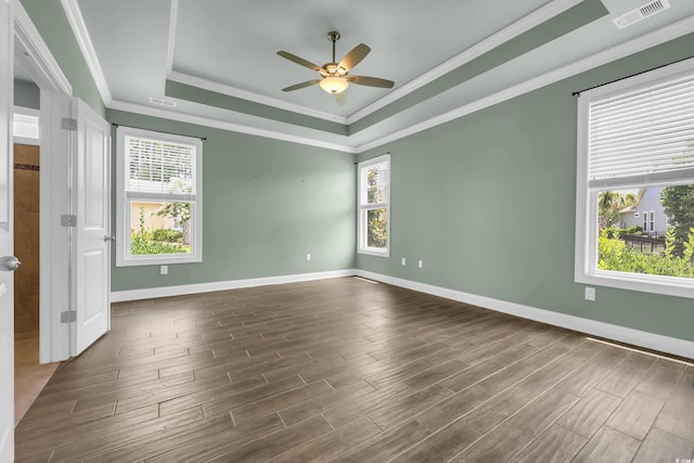 1405 Osprey Pointe Ln, North Myrtle Beach, SC 29582 - unfurnished room with a raised ceiling, a ceiling fan, crown molding, and dark wood-style flooring