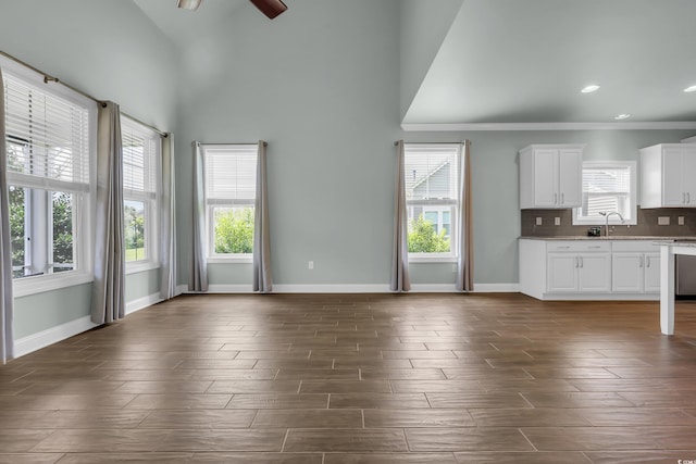 1405 Osprey Pointe Ln, North Myrtle Beach, SC 29582 - unfurnished living room with healthy amount of natural light, dark wood-type flooring, ceiling fan, high vaulted ceiling, and recessed lighting