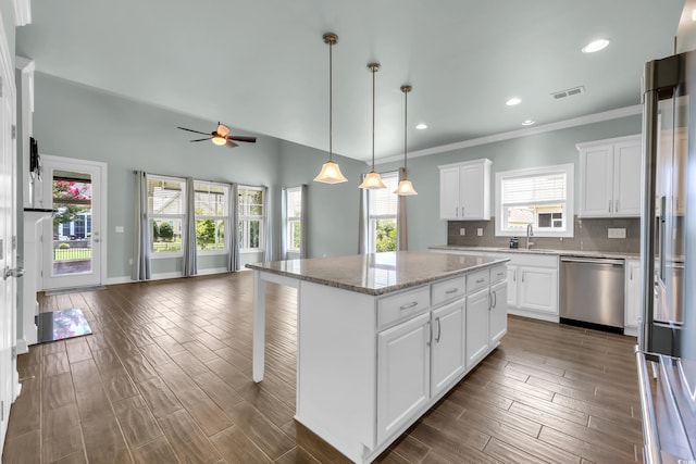 1405 Osprey Pointe Ln, North Myrtle Beach, SC 29582 - kitchen featuring stainless steel appliances, ceiling fan, open floor plan, a center island, and tasteful backsplash