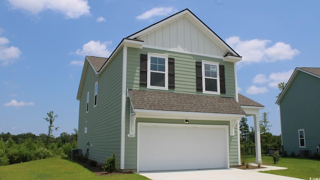 view of front of house with central AC unit, a front lawn, and a garage