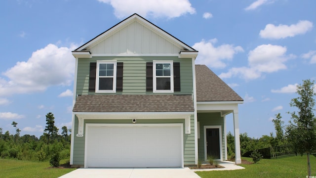 view of front of home featuring a front yard and a garage