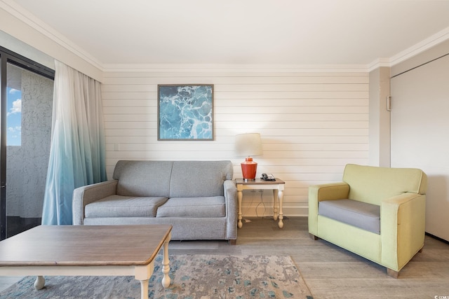 living room with crown molding and hardwood / wood-style floors