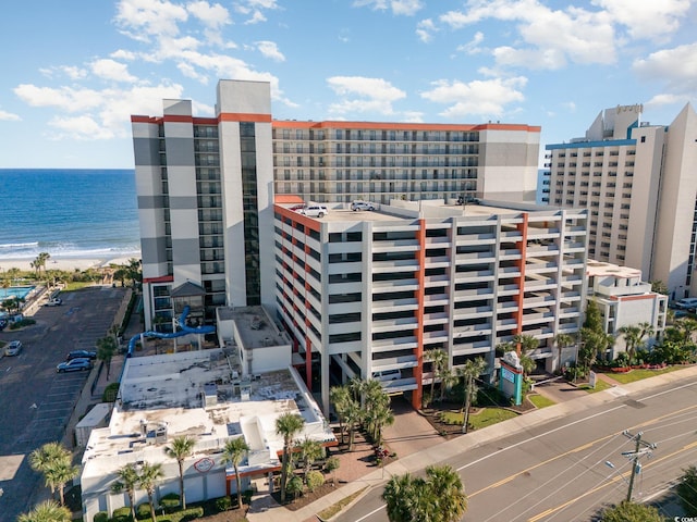 view of building exterior with a view of the beach and a water view