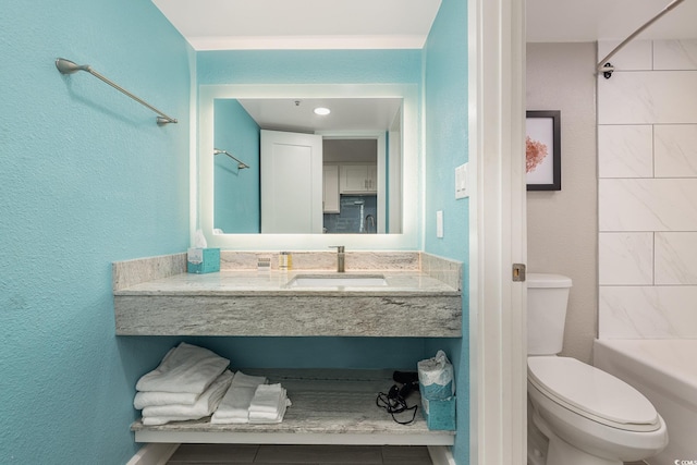 full bathroom featuring vanity, toilet, and tiled shower / bath