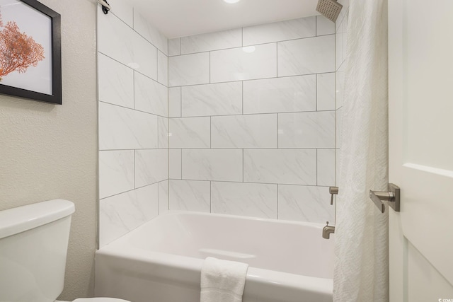 bathroom featuring shower / bath combo and toilet