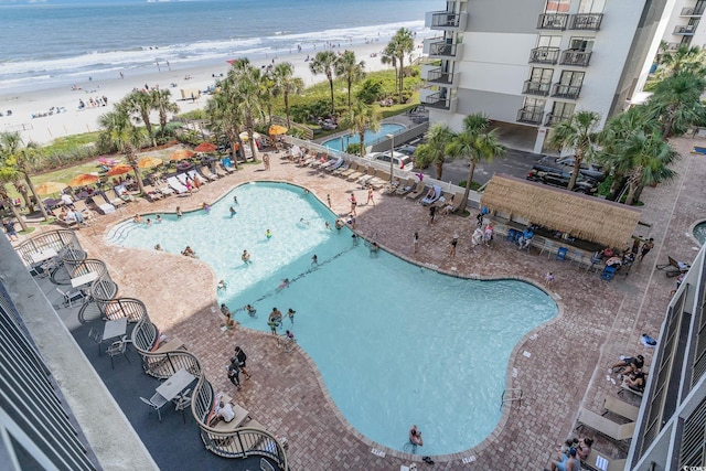 drone / aerial view featuring a view of the beach and a water view