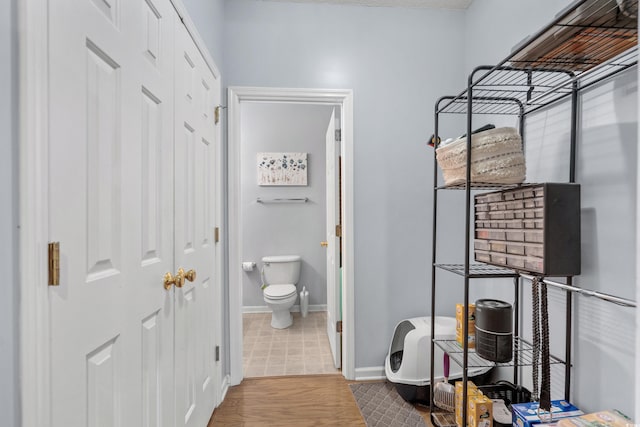 bathroom featuring hardwood / wood-style floors and toilet