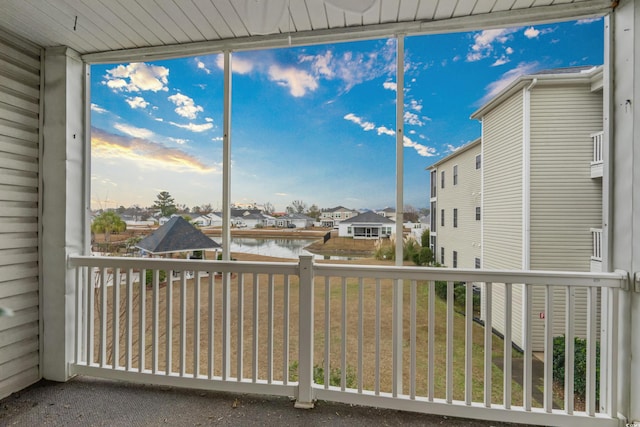 unfurnished sunroom featuring a water view