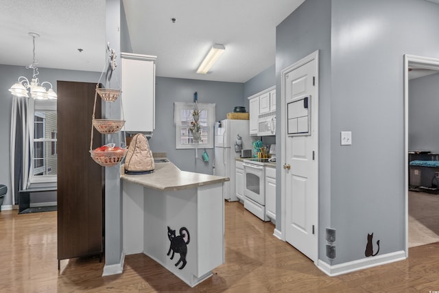 kitchen featuring light hardwood / wood-style floors, a notable chandelier, white cabinetry, and white appliances