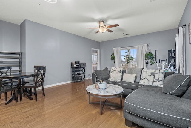 living room featuring ceiling fan and hardwood / wood-style flooring