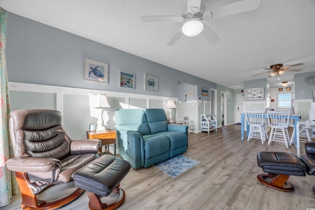 living room featuring ceiling fan and wood-type flooring