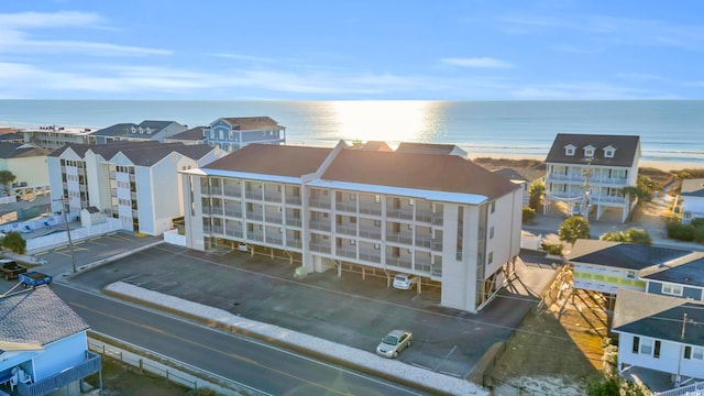 birds eye view of property with a water view and a beach view