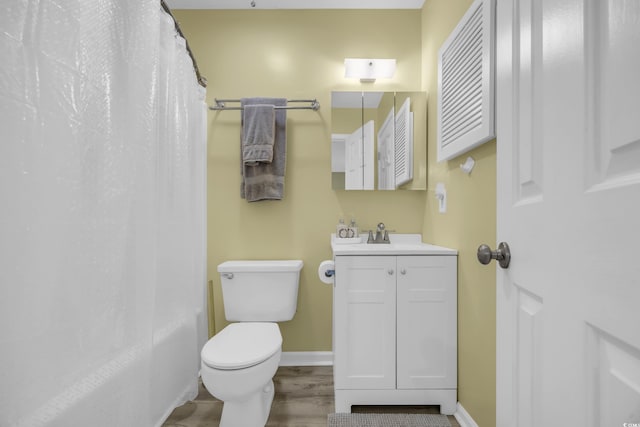 bathroom featuring vanity, wood-type flooring, and toilet