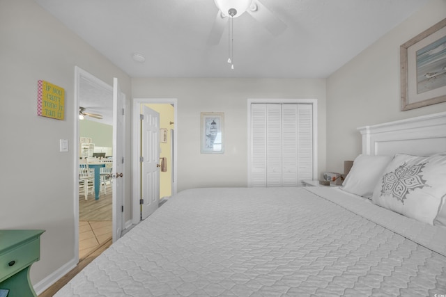 bedroom featuring ceiling fan, light wood-type flooring, and a closet