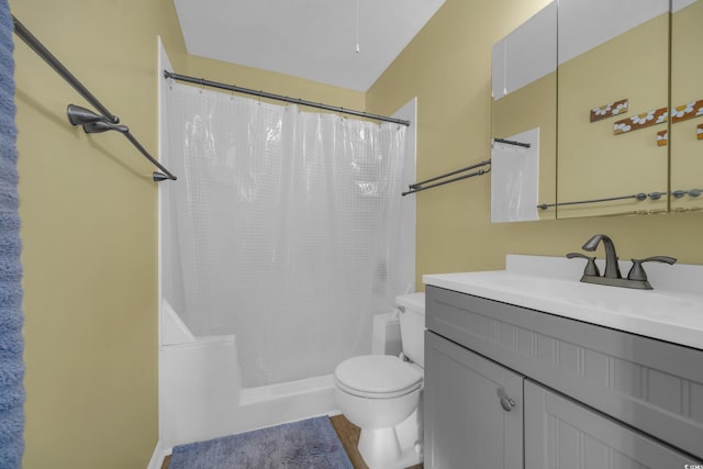 bathroom with curtained shower, vanity, and toilet