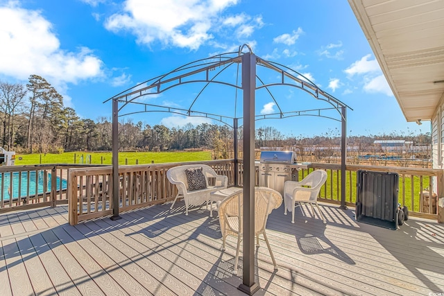 wooden terrace featuring a lawn and a gazebo