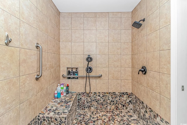 bathroom with a tile shower