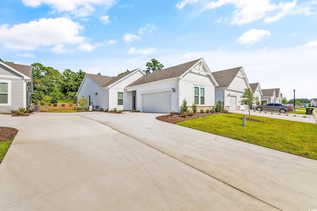 modern inspired farmhouse featuring a garage and a front yard