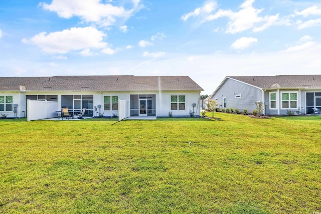 rear view of house featuring a yard and a patio area